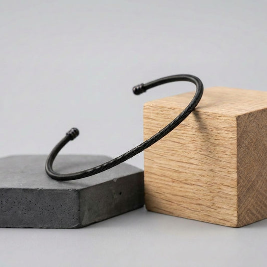 A bold minimal statement, this bracelet wraps strength and simplicity into one sleek form. With its clean coil texture and matte black finish, it delivers a modern, edgy vibe that elevates everyday wear effortlessly.