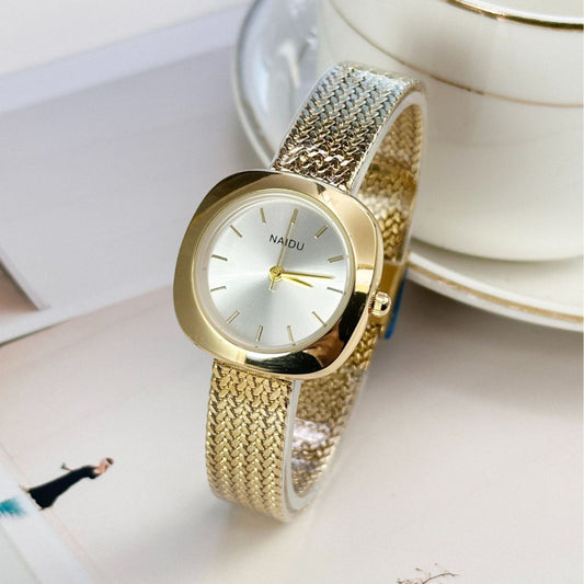 Designed for effortless everyday style, the Lume Classic Watch features a refined sunray dial with slim pointer markers, framed in a polished square case and finished with a stainless-steel mesh strap that drapes beautifully on the wrist. Minimal, feminine, and timeless.
