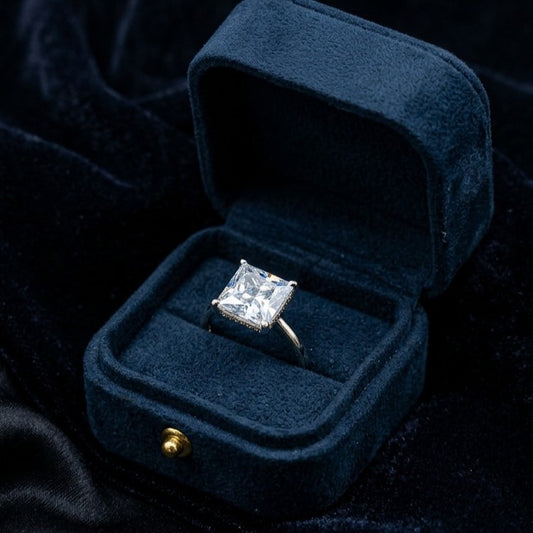 A radiant statement crafted to steal every glance, this ring captures the beauty of crystal-clear brilliance with its bold prism-cut centerpiece and sleek minimal band. Its luminous sparkle creates a luxurious yet timeless look that feels effortlessly elegant.