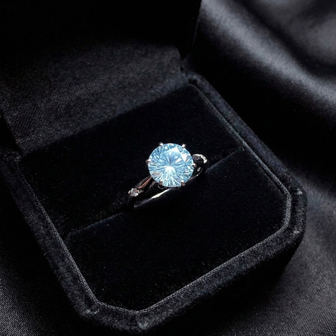 Lunara Ice Ring features a mesmerizing round sea-blue firework-cut stone that catches light from every angle. Set on a sleek silver-tone band, this ring delivers statement sparkle while remaining soft, feminine, and wearable for everyday moments.