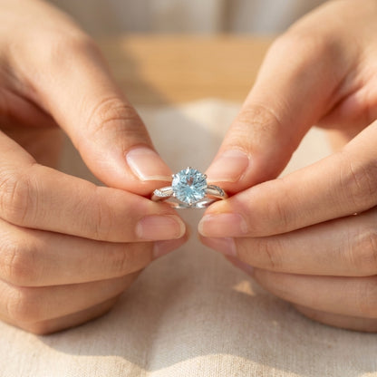 Lunara Ice Ring features a mesmerizing round sea-blue firework-cut stone that catches light from every angle. Set on a sleek silver-tone band, this ring delivers statement sparkle while remaining soft, feminine, and wearable for everyday moments.