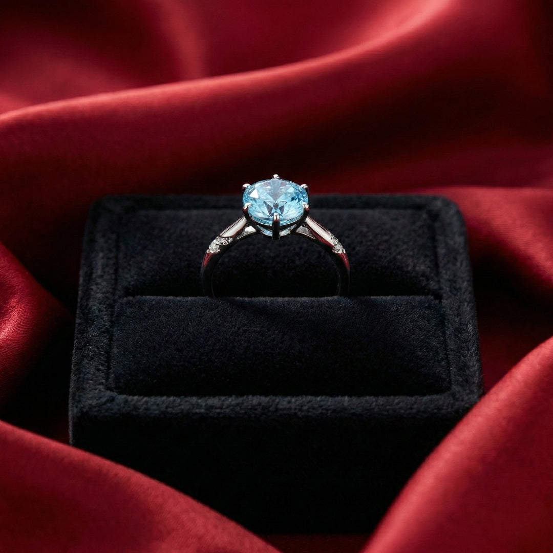 Lunara Ice Ring features a mesmerizing round sea-blue firework-cut stone that catches light from every angle. Set on a sleek silver-tone band, this ring delivers statement sparkle while remaining soft, feminine, and wearable for everyday moments.