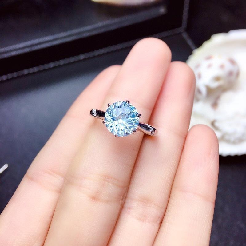 Lunara Ice Ring features a mesmerizing round sea-blue firework-cut stone that catches light from every angle. Set on a sleek silver-tone band, this ring delivers statement sparkle while remaining soft, feminine, and wearable for everyday moments.