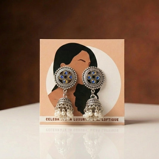 A graceful reflection of peacock-inspired artistry, this piece captures the beauty of iridescent hues and intricate detailing with a refined, elegant touch. The soft pearl drops paired with the ornate dome design create a gentle movement that feels both royal and timeless.