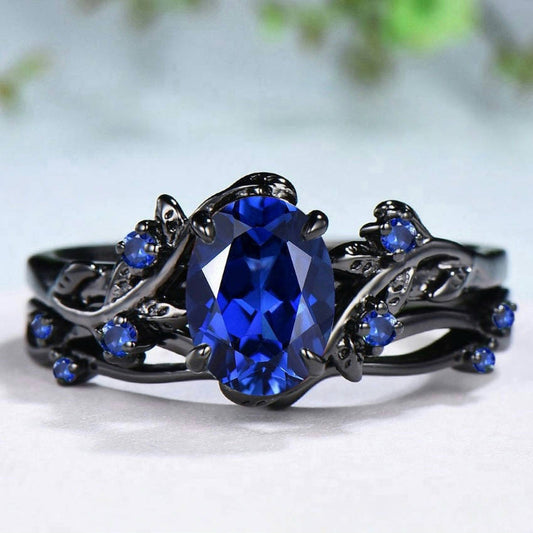The Sapphire Veil Rings,&nbsp;a fantasy inspired 2-layered ring set that embodies grace, power, and mystique. Featuring a dazzling deep-blue artificial gemstone nestled within vine-like curves and adorned with miniature sapphire accents, this set whispers stories of moonlit nights and hidden magic.
