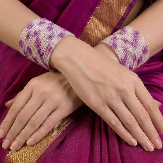A radiant blend of tradition and celebration, these bangles glow in a vibrant pink hue adorned with delicate golden accents that shimmer beautifully in the light. Their festive sparkle and graceful stacked look bring a joyful charm to every ethnic moment.
