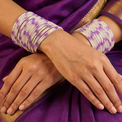 A radiant blend of tradition and celebration, these bangles glow in a vibrant pink hue adorned with delicate golden accents that shimmer beautifully in the light. Their festive sparkle and graceful stacked look bring a joyful charm to every ethnic moment.