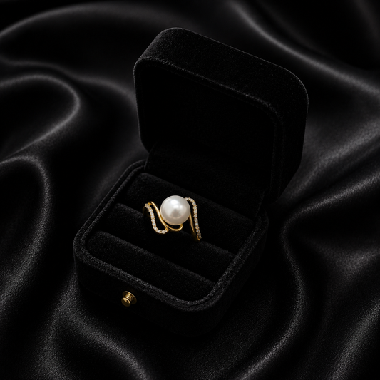Indulge in the ultimate blend of classic luster and modern artistry. The Opulent Swirl Ring features a breathtaking golden wave design that cradles a luminous center pearl, creating a silhouette that is as bold as it is sophisticated.
