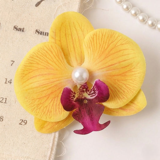 A graceful bloom designed to elevate everyday styling — the Orchid Pearl Clip captures the beauty of delicate orchid petals paired with a luminous pearl centerpiece. Soft, elegant, and effortlessly feminine, this floral hair accessory adds a natural charm to any hairstyle, turning even the simplest look into something beautifully refined.
