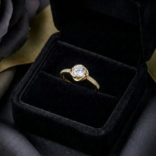 A delicate sparkle wrapped in graceful curves, Orlina Ring brings a soft elegance with its brilliant center stone embraced by flowing lines. Refined and timeless, it feels like a little piece of light resting on your hand.