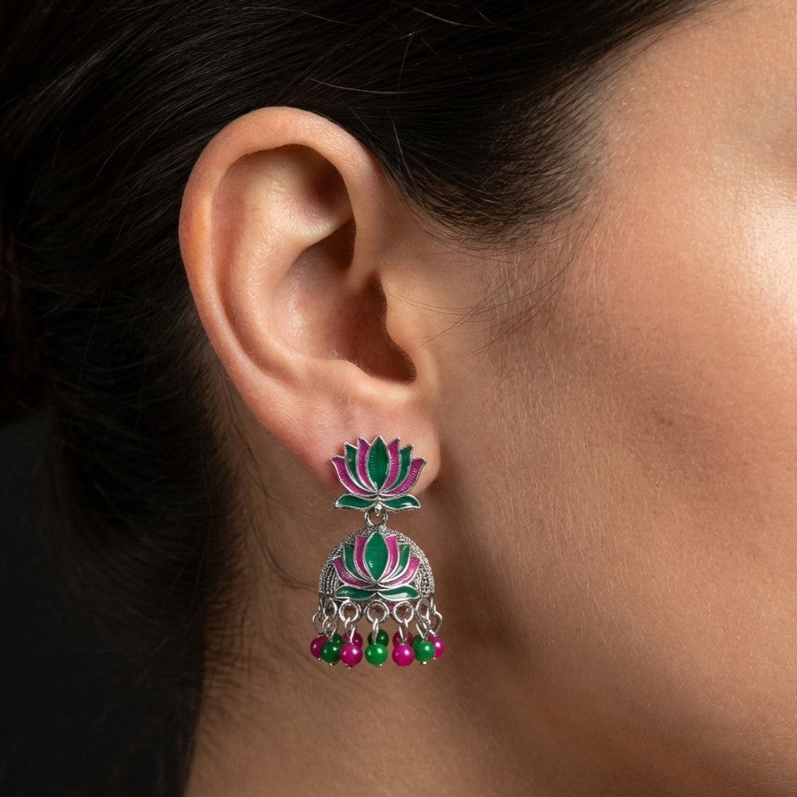A vibrant celebration of tradition and color, this piece captures the charm of lotus-inspired elegance with a playful festive touch. The blooming motif paired with lively red and green bead drops creates a graceful movement that feels joyful, eye-catching, and beautifully rooted in culture.