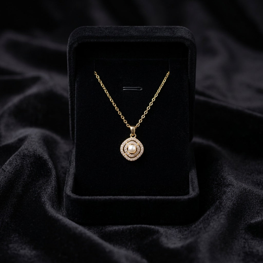 A delicate pearl framed within shimmering crystal layers, this necklace carries a soft radiant charm that feels timeless and elegant. Its minimal silhouette and graceful sparkle make it the perfect everyday piece with a luxurious feminine touch.