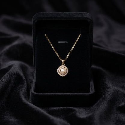 A delicate pearl framed within shimmering crystal layers, this necklace carries a soft radiant charm that feels timeless and elegant. Its minimal silhouette and graceful sparkle make it the perfect everyday piece with a luxurious feminine touch.