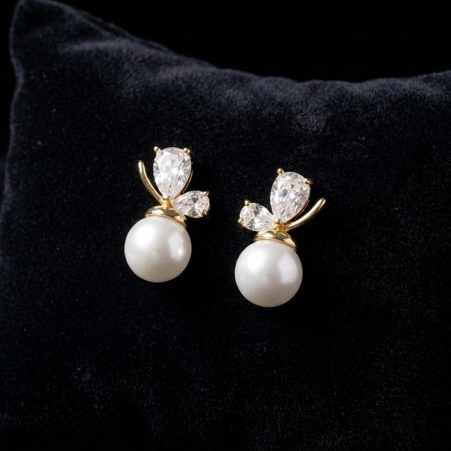 A soft cascade of pearls that feels like a blooming whisper the Pearl Bloom Drops bring together classic elegance and delicate charm in a design that flows with every movement. The graceful drop silhouette, paired with luminous pearl accents, creates a refined look that feels both timeless and effortlessly feminine.