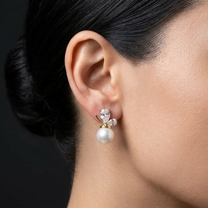A soft cascade of pearls that feels like a blooming whisper the Pearl Bloom Drops bring together classic elegance and delicate charm in a design that flows with every movement. The graceful drop silhouette, paired with luminous pearl accents, creates a refined look that feels both timeless and effortlessly feminine.