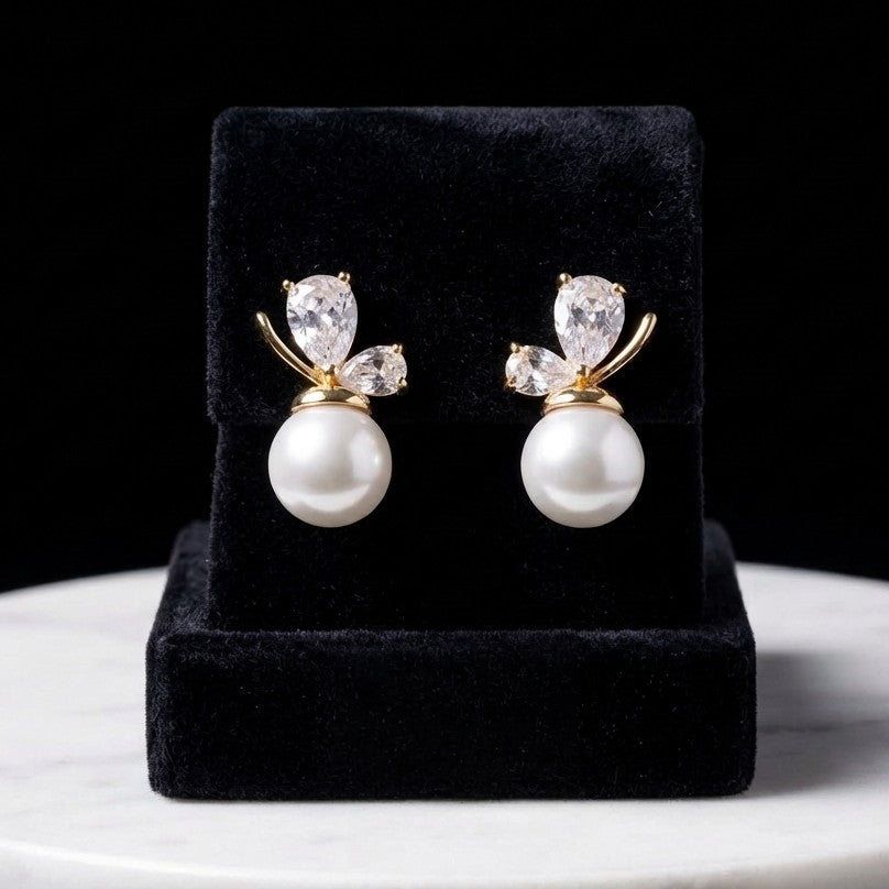 A soft cascade of pearls that feels like a blooming whisper the Pearl Bloom Drops bring together classic elegance and delicate charm in a design that flows with every movement. The graceful drop silhouette, paired with luminous pearl accents, creates a refined look that feels both timeless and effortlessly feminine.