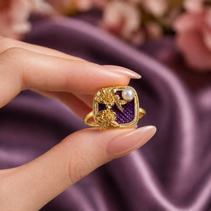 Like a hidden garden framed in gold, this elegant ring captures a graceful blend of blooming florals, luminous pearl beauty, and vintage-inspired charm. Featuring sculpted golden flowers over rich enamel detailing with a delicate pearl accent, it creates a refined statement that feels artistic, feminine, and effortlessly luxurious.