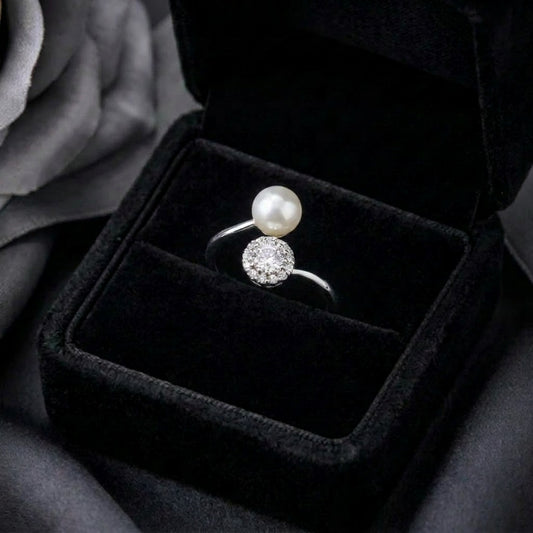 A graceful balance of luminous elegance and sparkling brilliance, this ring features a floating pearl paired with a radiant crystal cluster in a modern open silhouette. Its celestial-inspired design creates a soft statement that feels refined, timeless, and effortlessly elegant.