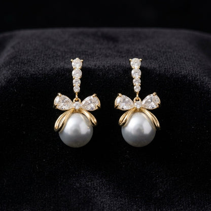A soft cascade of pearls tied with elegance the Pearl Ribbon Drops blend delicate charm with graceful movement. Designed with a bow-inspired top and flowing pearl strands, these earrings create a romantic silhouette that feels light, feminine, and effortlessly refined. Each drop sways gently with every step, adding a subtle glow to both everyday looks and special moments
