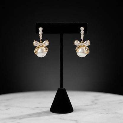 A soft cascade of pearls tied with elegance the Pearl Ribbon Drops blend delicate charm with graceful movement. Designed with a bow-inspired top and flowing pearl strands, these earrings create a romantic silhouette that feels light, feminine, and effortlessly refined. Each drop sways gently with every step, adding a subtle glow to both everyday looks and special moments