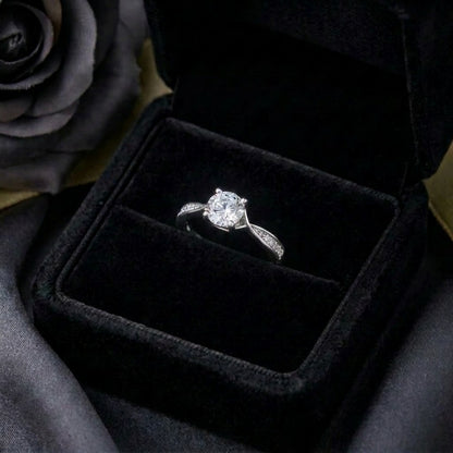A graceful flow captured in delicate curves, Rivelle Flowelle Ring blends timeless sparkle with a soft wave silhouette. The flowing band embraces the brilliant center stone beautifully, creating an elegant piece that feels refined, romantic, and effortlessly wearable.