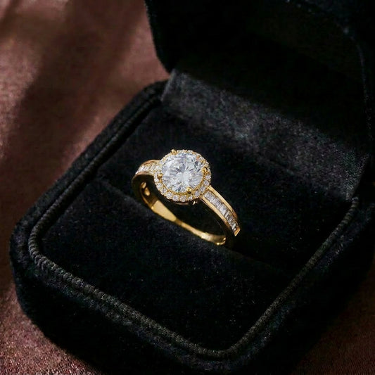 A timeless bloom of brilliance, this ring features a radiant center stone embraced by a shimmering halo that reflects light beautifully from every angle. Its classic silhouette and delicate sparkle create an elegant charm that feels refined, romantic, and everlasting.