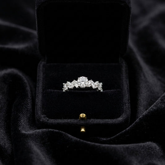 A graceful shimmer wrapped in timeless elegance, this ring blends delicate sparkle with a softly sculpted silhouette that feels effortlessly refined. The intertwined crystal design catches light beautifully, creating a subtle statement perfect for both everyday styling and special moments.