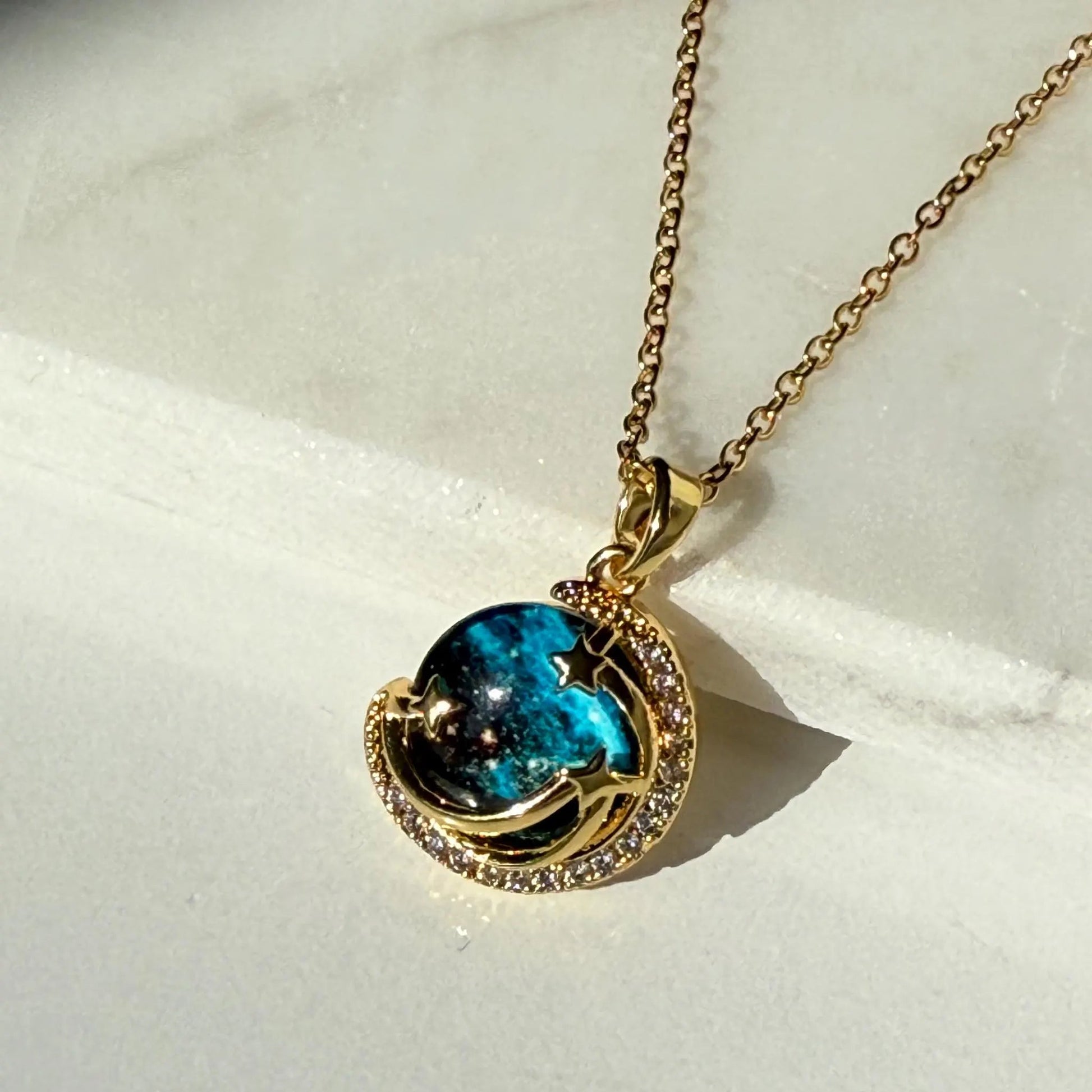 Unveil the elegance of the cosmos with the Stardust Whisper Necklace, a breathtaking creation crafted from premium titanium steel and plated with a durable titanium finish. This necklace features a mesmerizing cosmic-inspired pendant, adorned with glimmering zircon stones that catch the light from every angle.