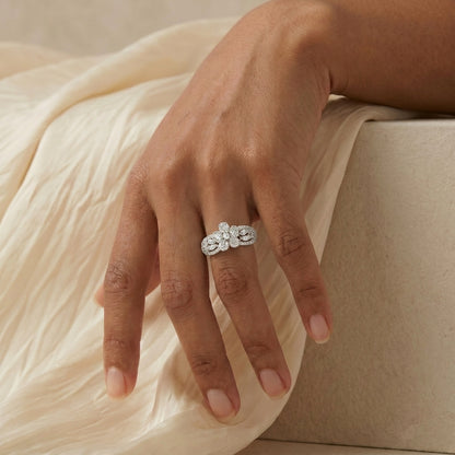 Like delicate starlight woven into an elegant lace pattern, this radiant ring captures a graceful blend of sparkle, artistry, and timeless feminine charm. Featuring clustered crystal blooms paired with intricate openwork detailing, it creates a refined statement that feels enchanting, sophisticated, and effortlessly luxurious.