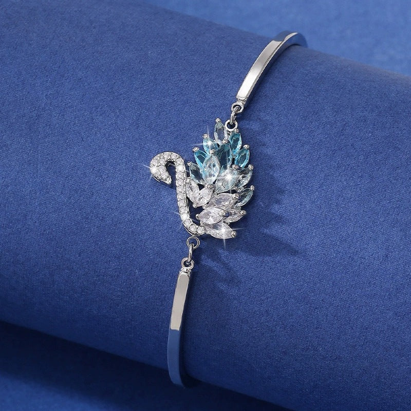 A graceful swan silhouette with leaf-like crystals—minimal from afar, breathtaking up close. Swanveil Lumi Bracelet is that soft-luxury sparkle that instantly makes your wrist look polished and expensive.

