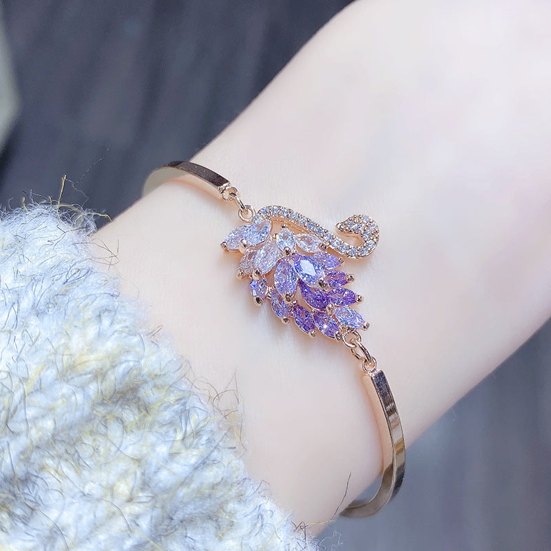 A graceful swan silhouette with leaf-like crystals—minimal from afar, breathtaking up close. Swanveil Lumi Bracelet is that soft-luxury sparkle that instantly makes your wrist look polished and expensive.

