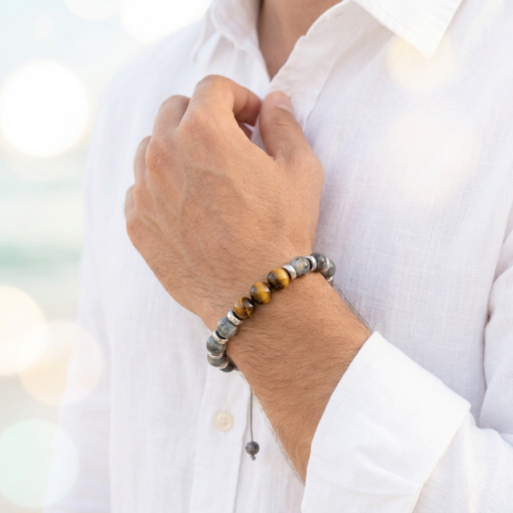 A bold fusion of strength and flow, this bracelet captures a powerful yet balanced energy in a sleek, modern form. With its deep-toned stones and subtle metallic accents, it reflects a confident presence that feels both grounded and refined.
