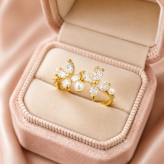 A graceful celebration of transformation and beauty, this ring features two sparkling butterfly motifs adorned with brilliant crystal stones and delicate pearl accents. Its open silhouette creates a light, airy charm that feels feminine, elegant, and effortlessly enchanting.