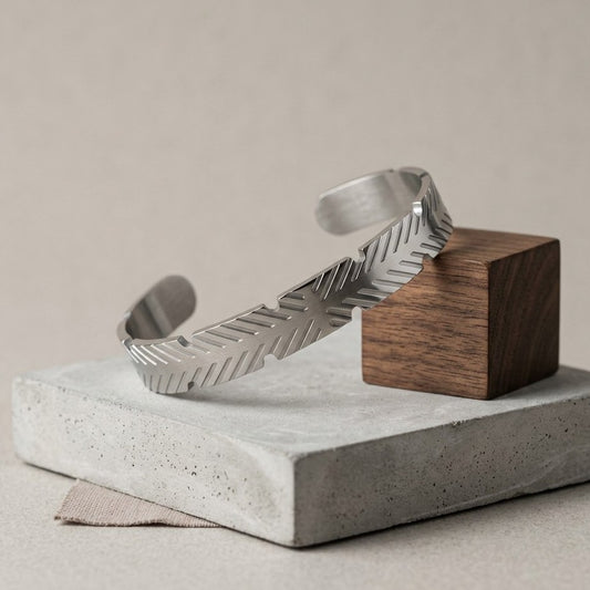 A sharp expression of modern style, this cuff features clean geometric cuts that create a bold, edgy look. Its structured design and sleek finish give off a confident, urban vibe—perfect for those who like their accessories minimal yet striking.