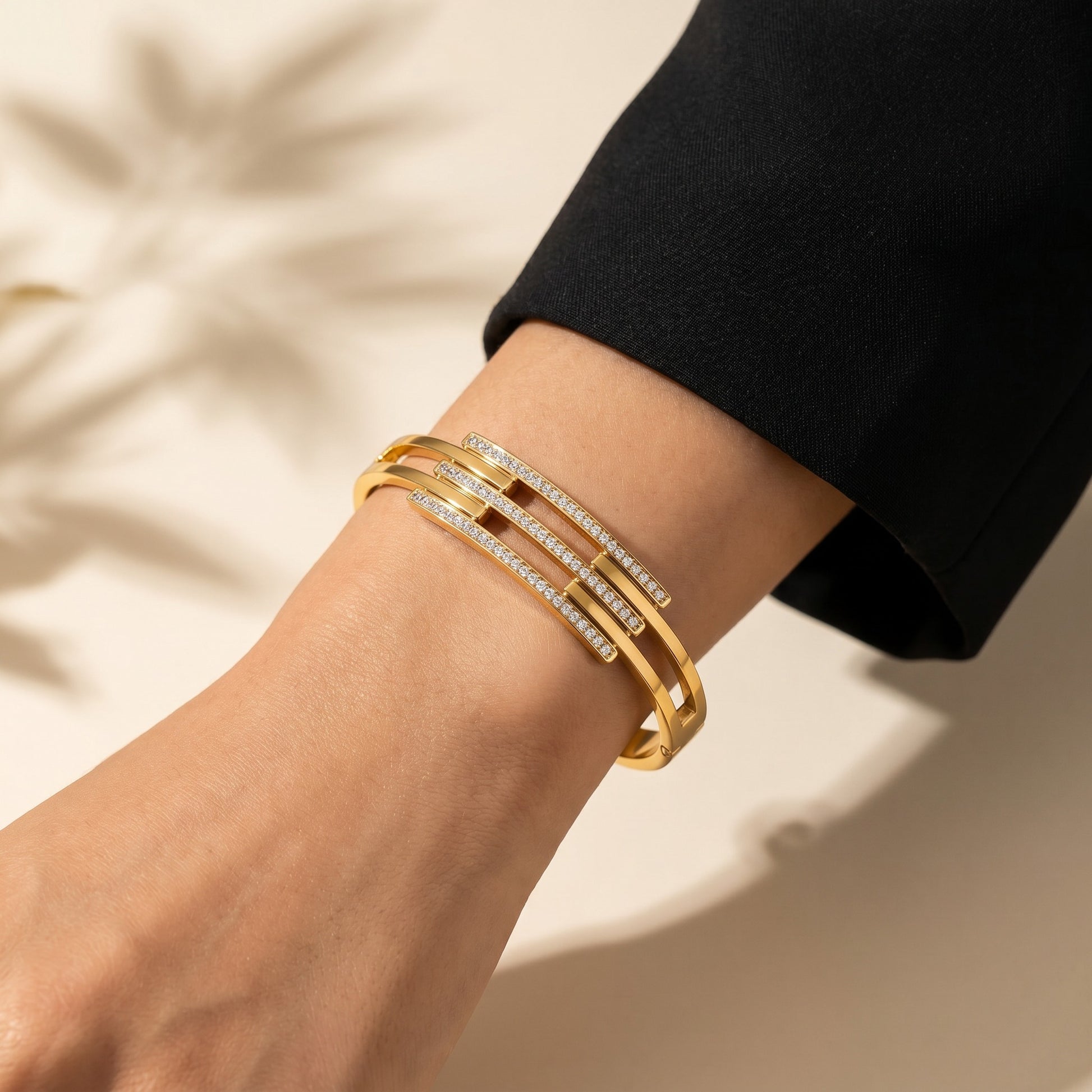 A refined play of clean lines and crystal brilliance, this cuff captures modern elegance in a sleek layered silhouette. The parallel crystal bars paired with a polished gold finish create a statement look that feels both bold and effortlessly sophisticated.