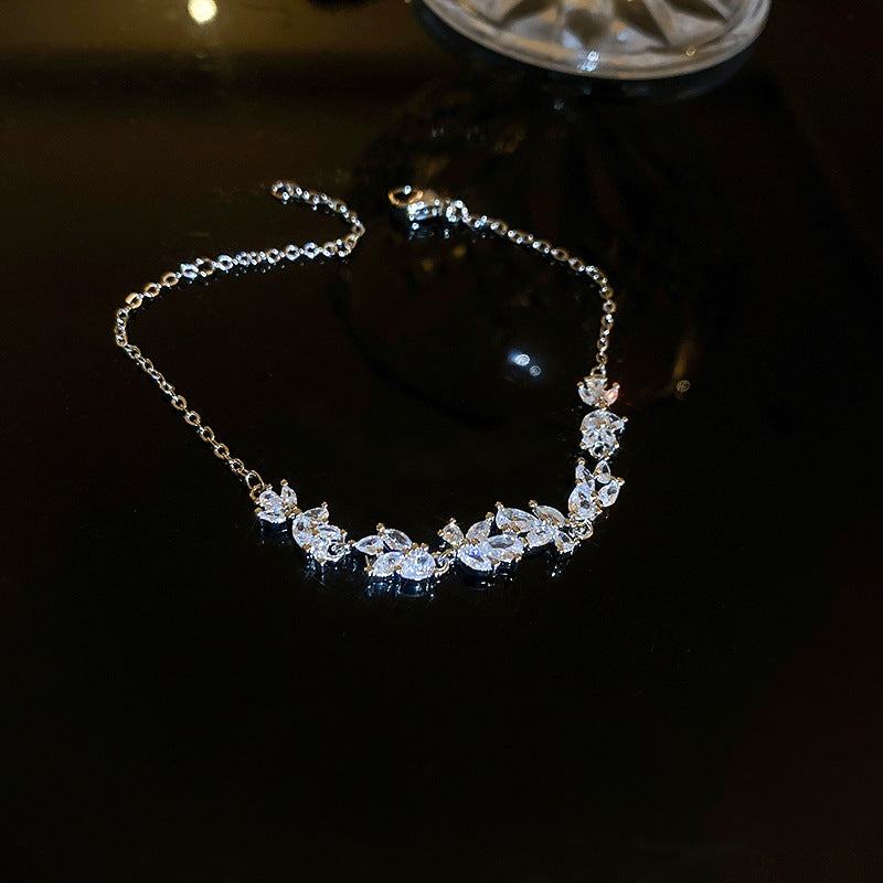 Graceful as falling petals in spring light, the Wisteria Petal Set glistens with pure sophistication. Each zircon stone is delicately cut and arranged in a floral flow, forming a soft cascade of brilliance that mirrors nature’s poetry. Crafted with premium zircon and finished with precision.