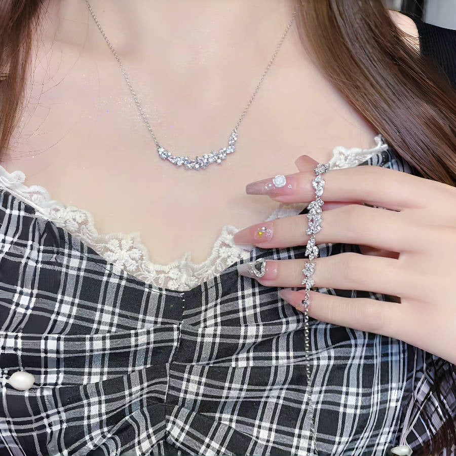 Graceful as falling petals in spring light, the Wisteria Petal Set glistens with pure sophistication. Each zircon stone is delicately cut and arranged in a floral flow, forming a soft cascade of brilliance that mirrors nature’s poetry. Crafted with premium zircon and finished with precision.