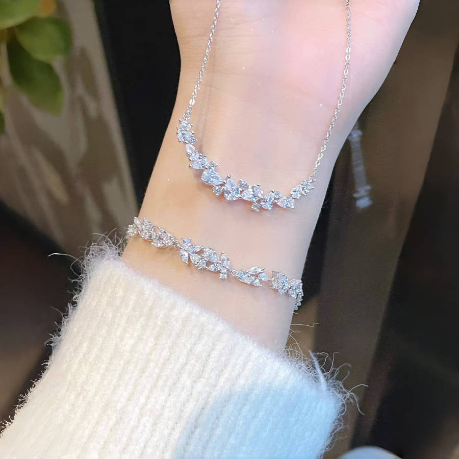 Graceful as falling petals in spring light, the Wisteria Petal Set glistens with pure sophistication. Each zircon stone is delicately cut and arranged in a floral flow, forming a soft cascade of brilliance that mirrors nature’s poetry. Crafted with premium zircon and finished with precision.