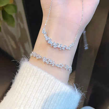 Graceful as falling petals in spring light, the Wisteria Petal Set glistens with pure sophistication. Each zircon stone is delicately cut and arranged in a floral flow, forming a soft cascade of brilliance that mirrors nature’s poetry. Crafted with premium zircon and finished with precision.