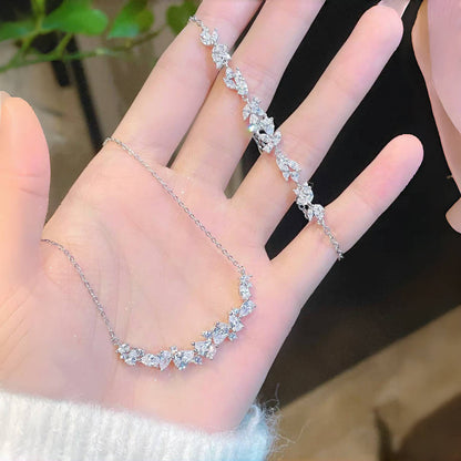 Graceful as falling petals in spring light, the Wisteria Petal Set glistens with pure sophistication. Each zircon stone is delicately cut and arranged in a floral flow, forming a soft cascade of brilliance that mirrors nature’s poetry. Crafted with premium zircon and finished with precision.