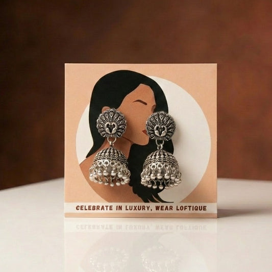A timeless piece inspired by heritage artistry, the Zariya Heritage Jhumka reflects the beauty of intricate craftsmanship with a bold traditional charm. Its detailed patterns and graceful dome silhouette create a striking presence that feels both regal and elegant.