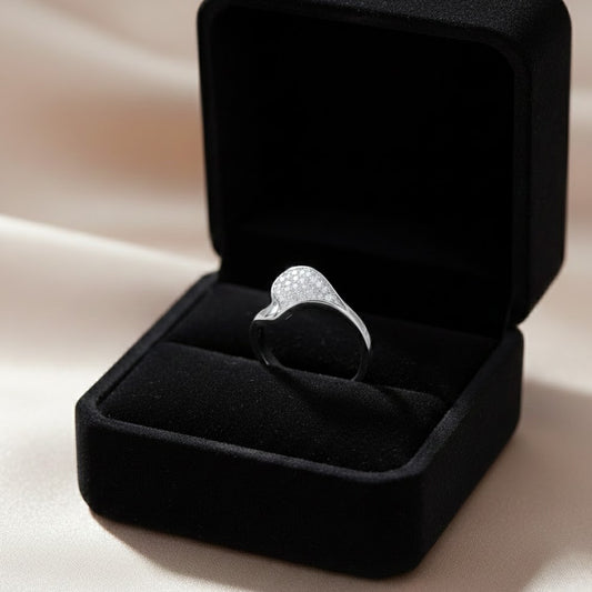 A refined statement ring shaped by gentle curves and subtle brilliance. The Zerelle Curve Ring features a fluid asymmetrical silhouette, accented with delicately set zircon stones that shimmer softly within its sculpted frame. Minimal yet expressive, it’s designed for those who love elegance that feels effortless, modern, and wearable every day.